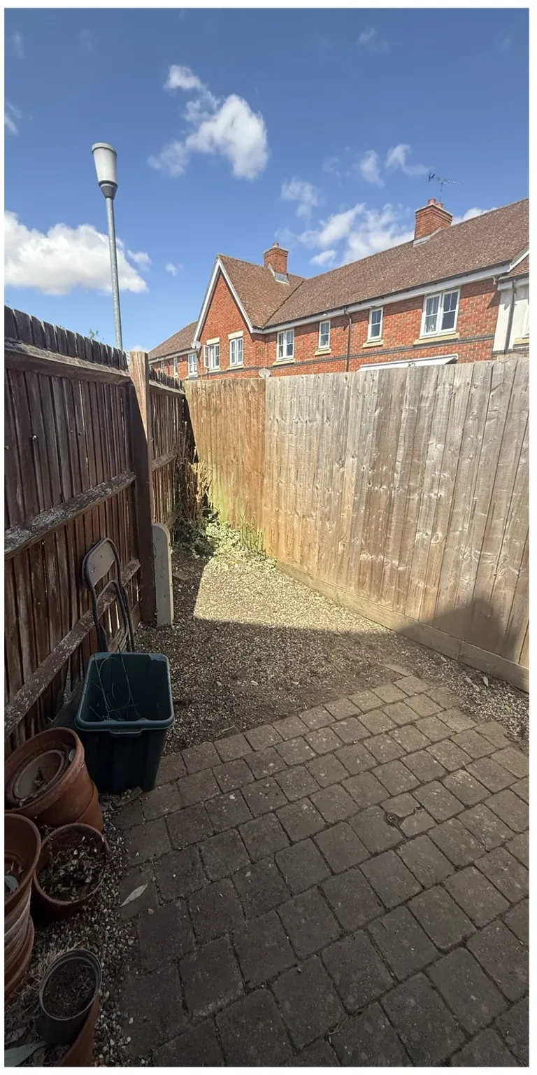 Narrow side garden after weeds and overgrowth were cleared