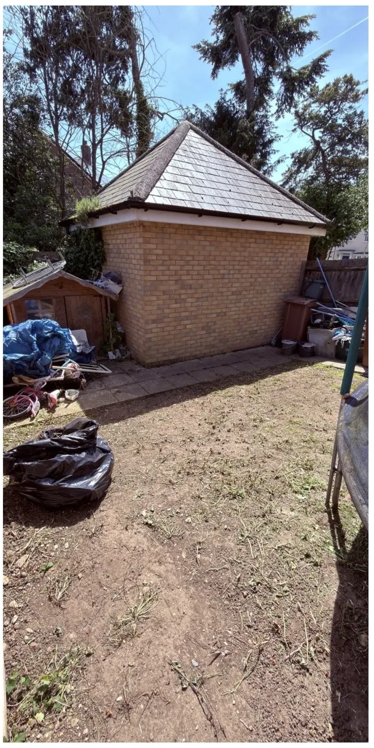 Same garden area cleared of tall weeds and overgrowth